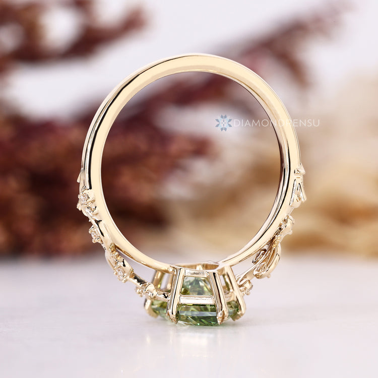 Nature inspired green Dutch marquise engagement ring with leaf style prongs.