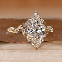 Handmade marquise diamond ring with leaf style prongs.