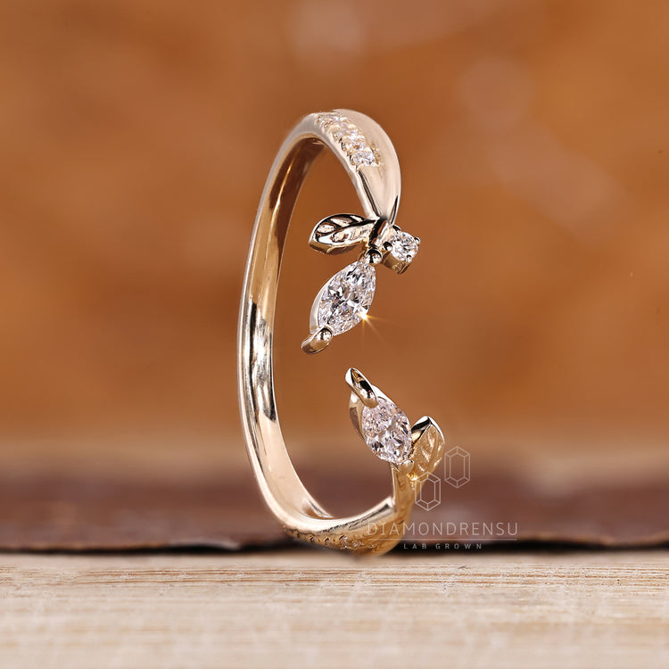 Marquise stone wedding band with open gap and clean design.