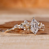 Marquise and round diamond bridal set with leaf details.