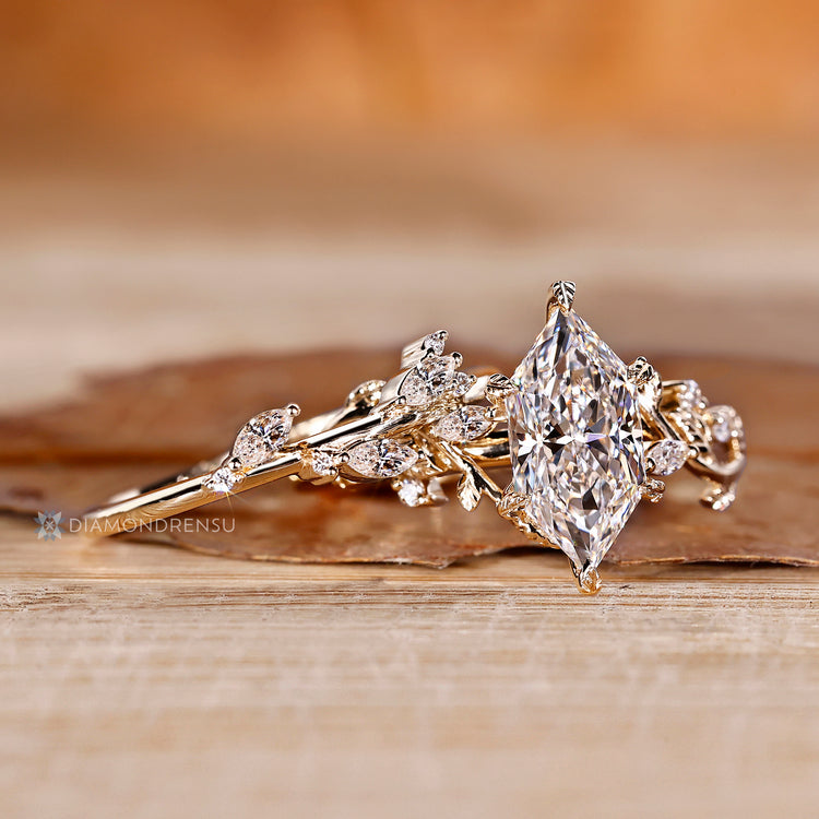Marquise and round diamond bridal set with leaf details.