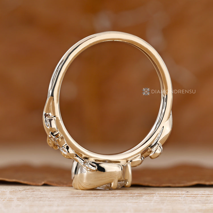 Half bezel engagement ring with round side stones.