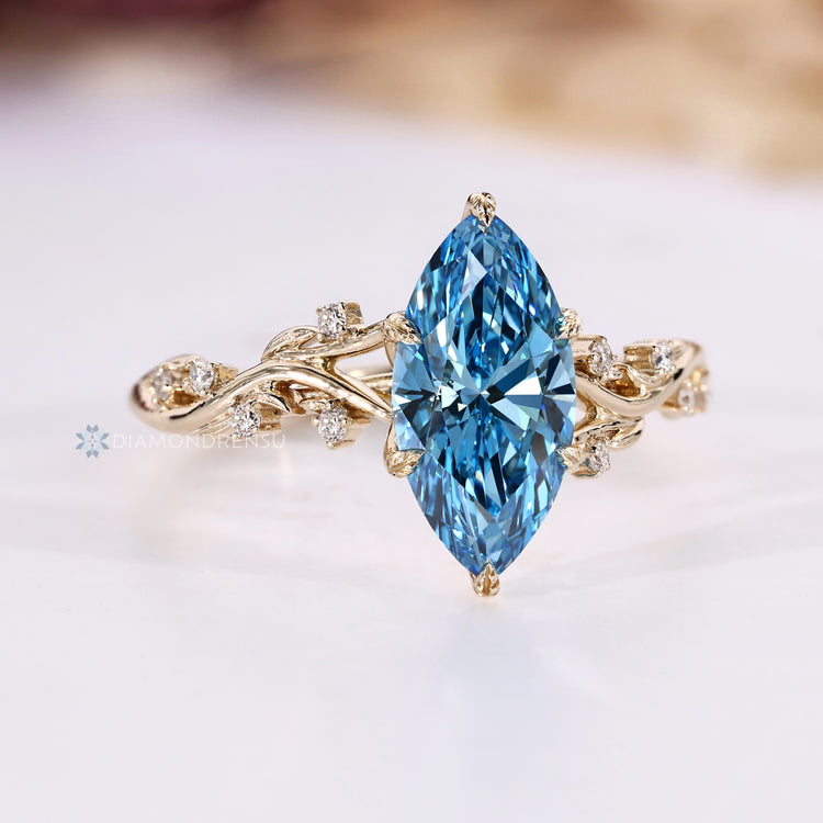 Marquise engagement ring with a hidden round cut blue sapphire.