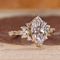 Diamondrensu engagement ring with marquise diamond and round cut side stones.
