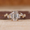 Nature inspired engagement ring with emerald old european cut diamond center.
