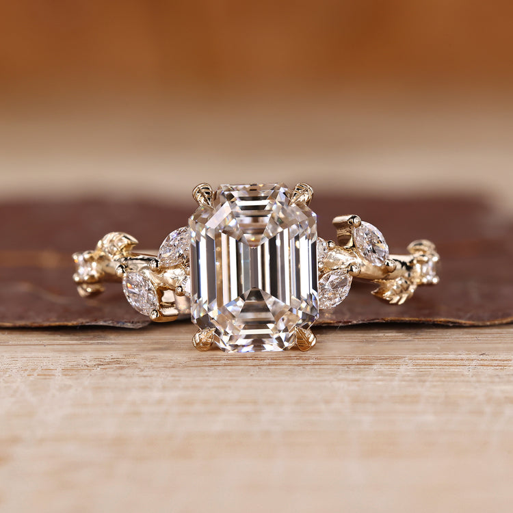 Nature inspired engagement ring with emerald old european cut diamond center.
