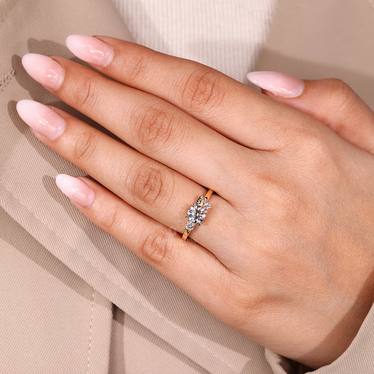 Nature inspired ring with leaf details and round side stones.
