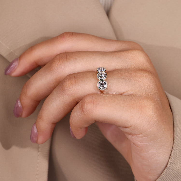Lab grown cushion old european cut diamond three stone ring.

