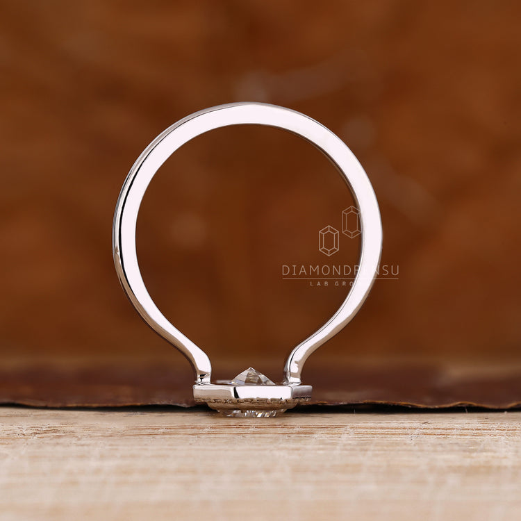 Coffin cut diamond ring with open gallery and bezel style.