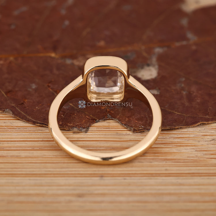 Handmade cushion engagement ring with clean solitaire design.