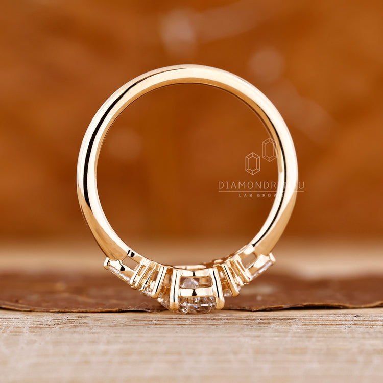 Diamondrensu oval ring with marquise and round side stones.