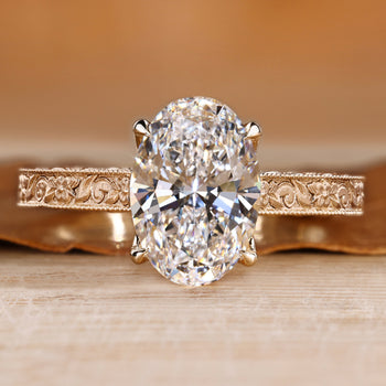 Art Deco engagement ring with oval center stone and milgrain details.