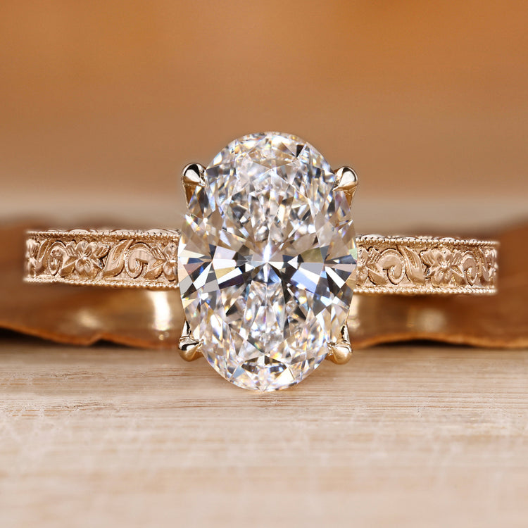 Art Deco engagement ring with oval center stone and milgrain details.