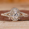 Oval diamond engagement ring with round cut halo style and split shank.