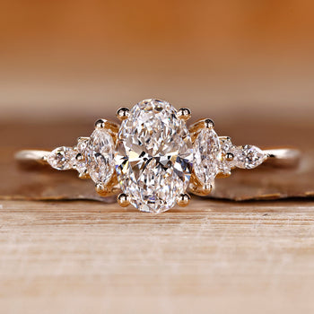 Oval shaped engagement ring with muse setting and side stones.