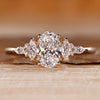 Oval shaped engagement ring with muse setting and side stones.