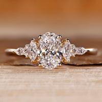 Oval shaped engagement ring with muse setting and side stones.