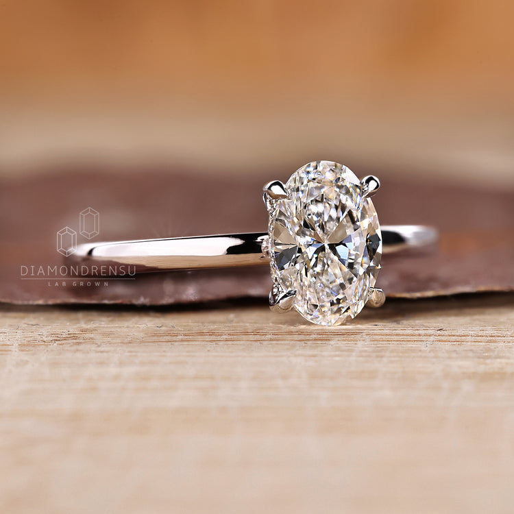 Handmade oval diamond ring with round cut hidden halo.