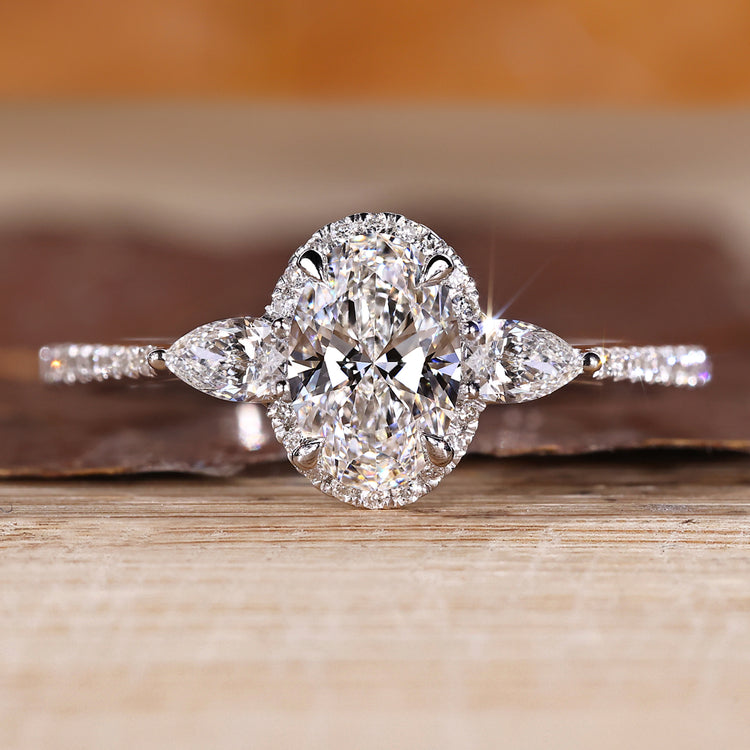 Oval cut lab grown diamond ring with pear side stones.