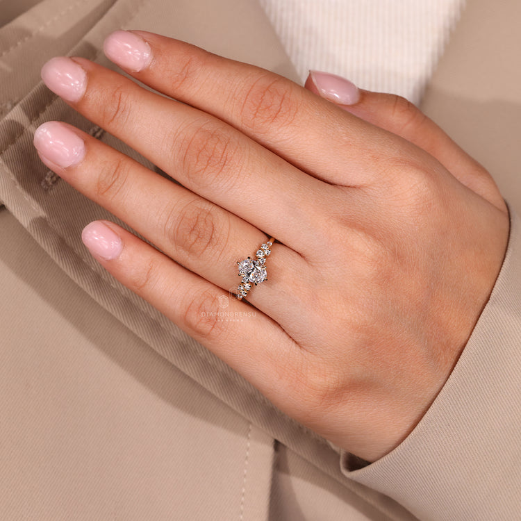 Cluster setting oval ring with brilliant round accents.
