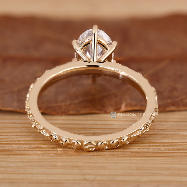 Oval nature inspired ring with a six claw prong setting.