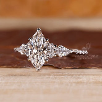 Round and kite cut side stone diamond ring.
