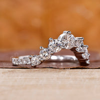 Prong set band holding diamonds securely with open light reflection.
