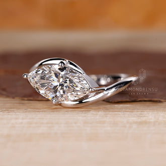 White gold ring with four prong marquise diamond.
