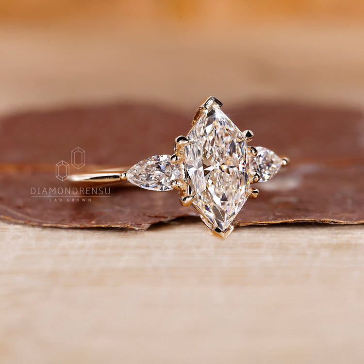 Buy engagement ring with three stone engagement ring design, Dutch marquise ring, and two pear cut side stones.
