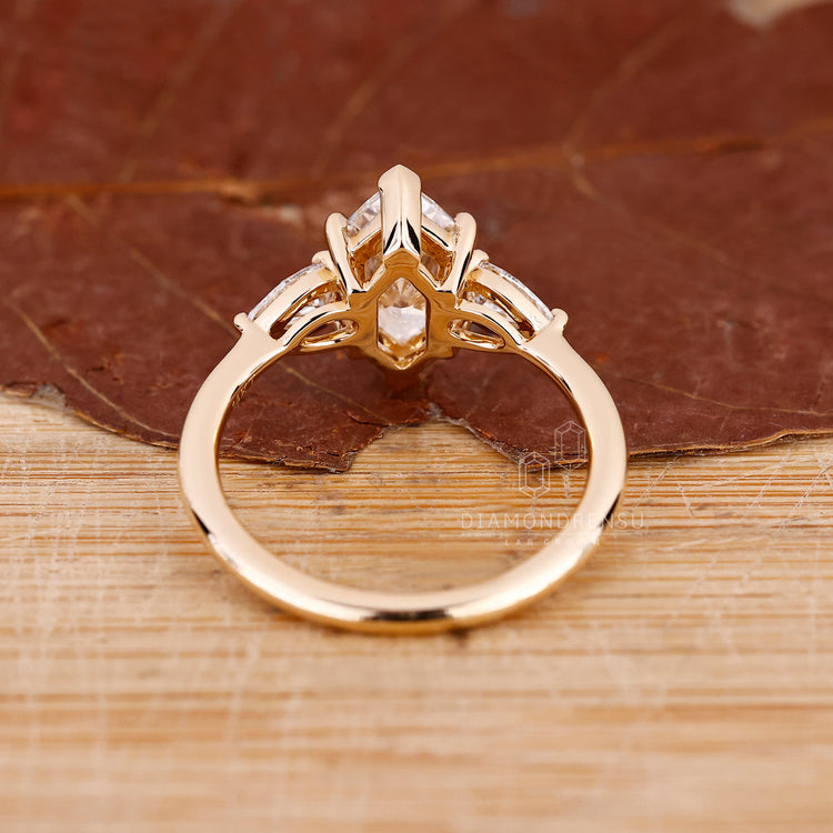 Handmade ring with three stone engagement ring, Dutch marquise ring, and two pear cut side stones in diamondrensu engagement ring.
