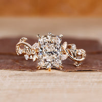 Radiant cut diamond ring with six leaf style prong in yellow gold
