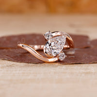 Rose gold engagement ring with round side diamonds.
