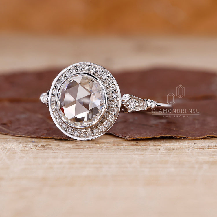 White gold engagement ring with round rose cut and bezel design.

