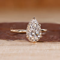 Custom diamond ring designed with pear cut and hidden halo brilliance.
