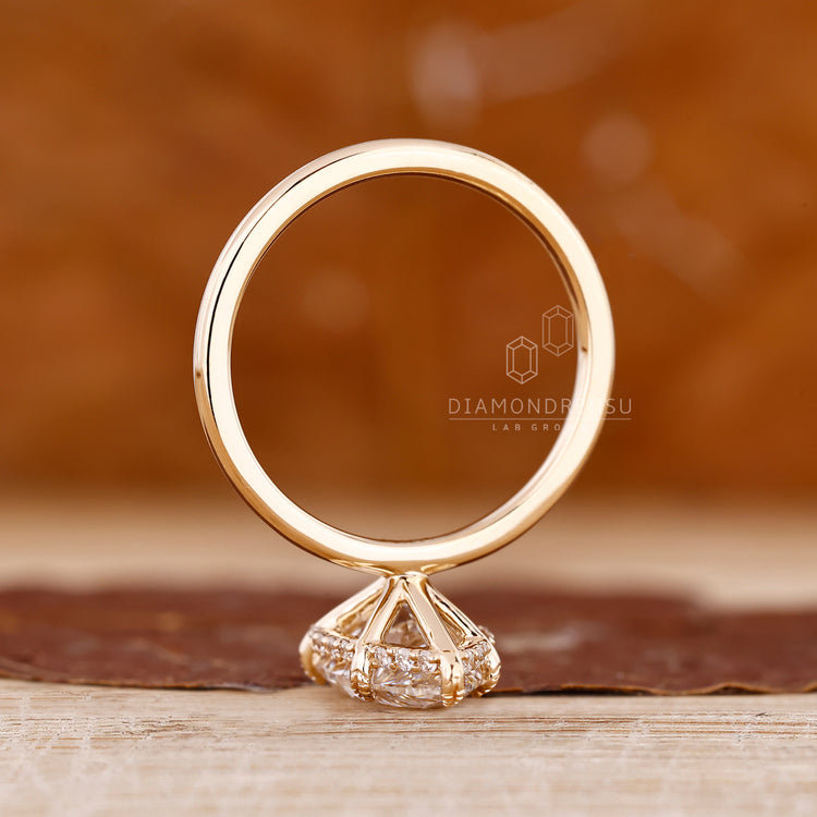 Handmade ring with pear cut diamond and hidden halo design.
