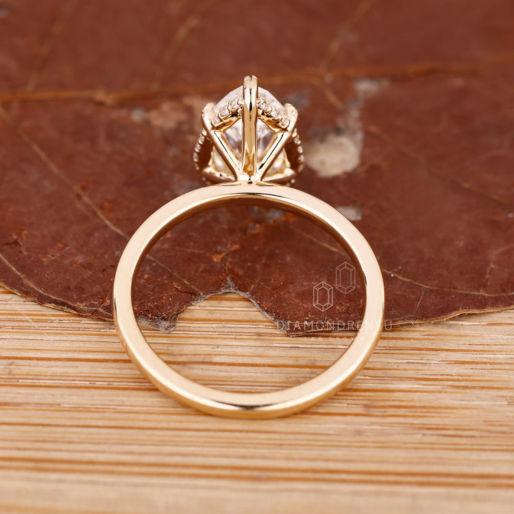 Yellow gold pear cut diamond ring with secure and elegant prong setting.
