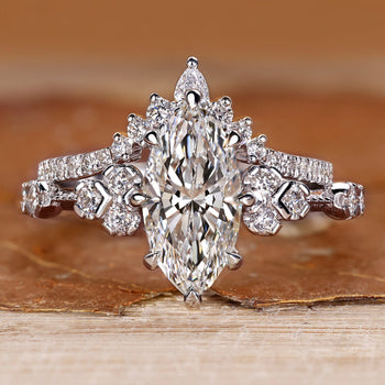 Marquise wedding ring with round side stones and vintage style.