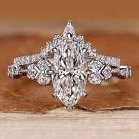 Marquise wedding ring with round side stones and vintage style.