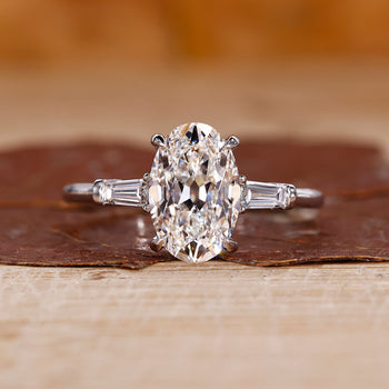 3 stone engagement ring features an oval old european cut diamond.
