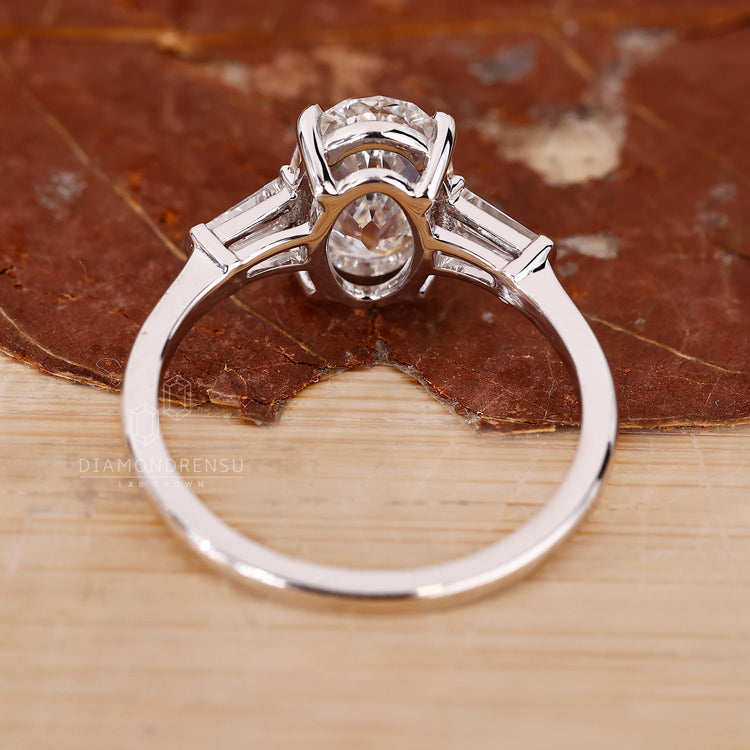 Oval old european cut diamond pairs with tapered baguette side stones.
