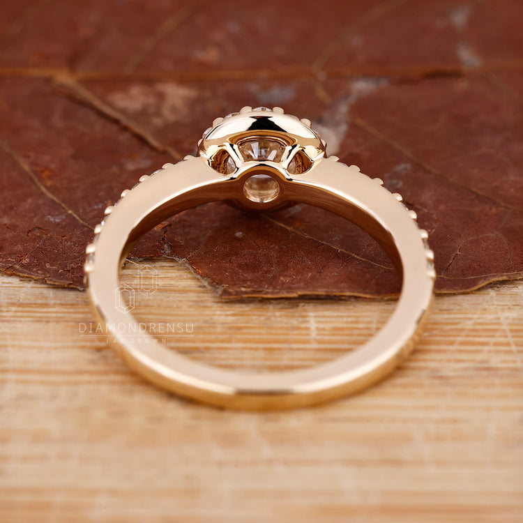 Diamondrensu engagement ring with a round halo design.
