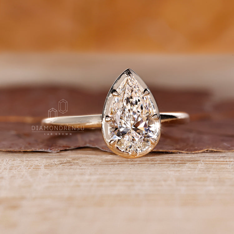 Solitaire setting pear cut diamond engagement ring Diamondrensu.
