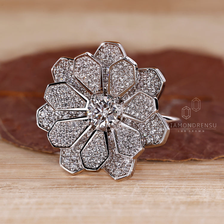 Nature inspired engagement ring with cluster of diamonds in white gold.
