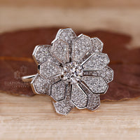 White gold ring with cluster diamond engagement design and four prong setting.
