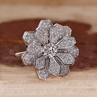 White gold ring with cluster diamond engagement design and four prong setting.
