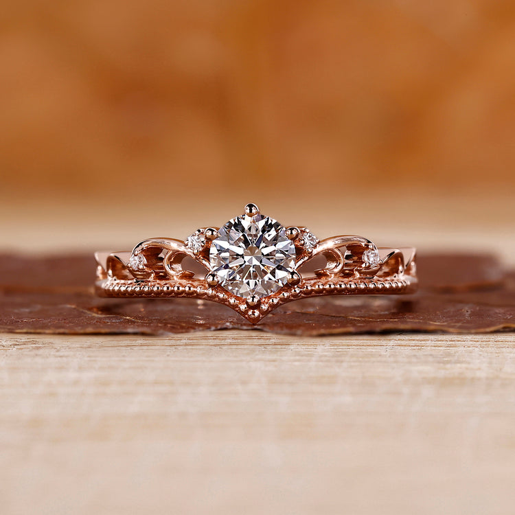 Round cut diamond engagement ring with rose gold band.

