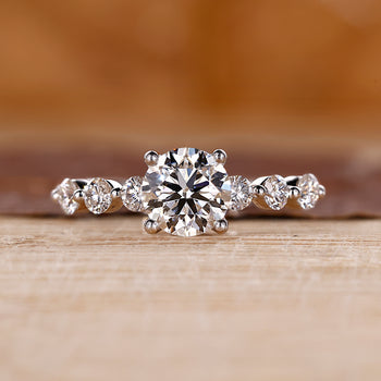 7 stone engagement ring with round cut diamonds in white gold.
