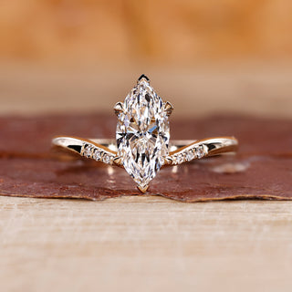 Yellow gold marquise diamond engagement ring with bold design.
