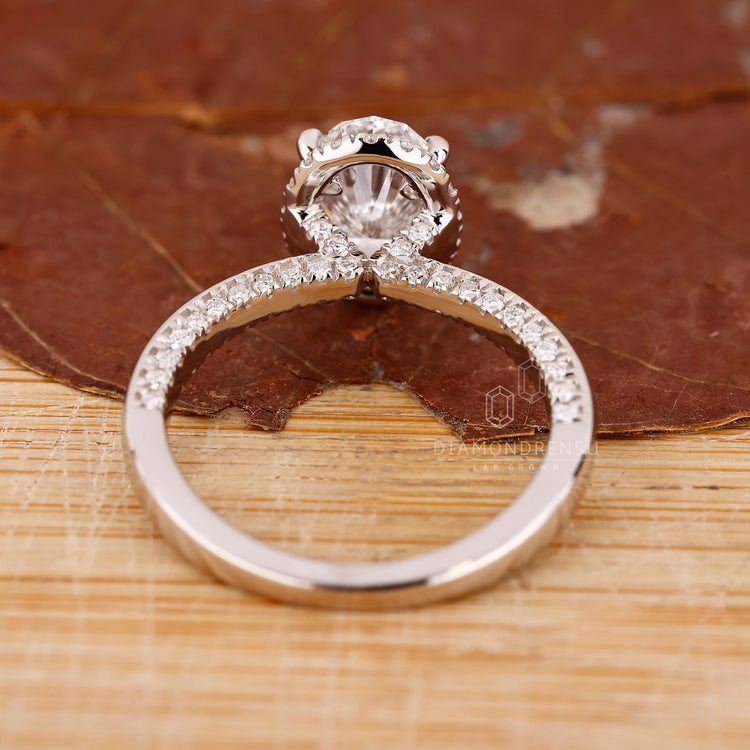 Handmade Jewelry, featuring a round cut diamond in a white gold halo setting.
