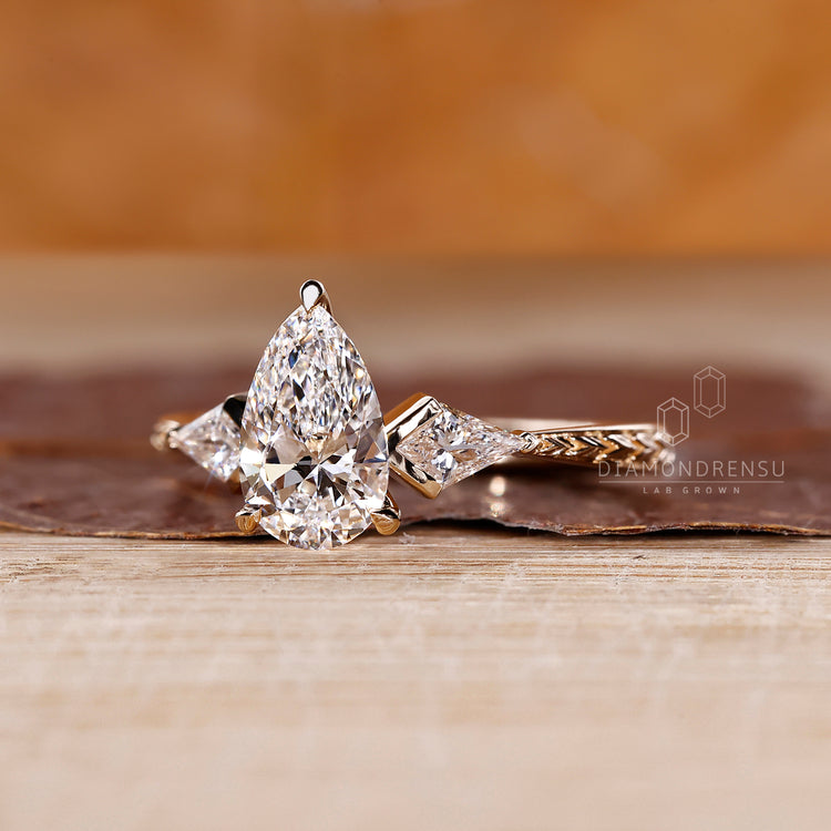 Pear cut engagement ring with tapered shank and 3 claw prong setting.
